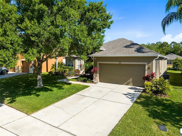 view of front facade featuring a garage, a shingled roof, driveway, stucco siding, and a front yard