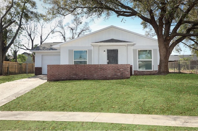 view of front of property featuring concrete driveway, brick siding, a front yard, and fence