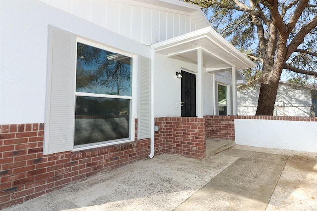 doorway to property with brick siding