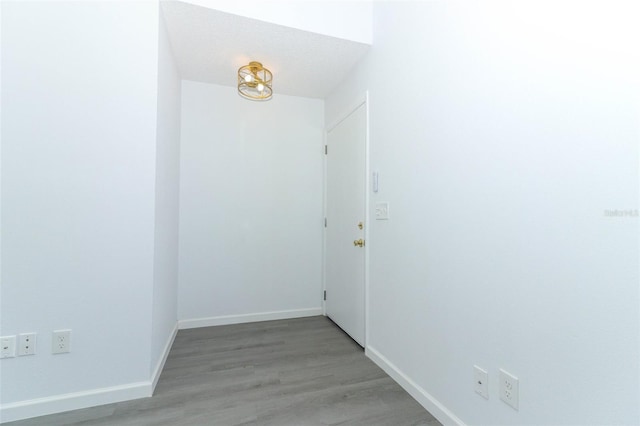 spare room with light wood-type flooring and baseboards