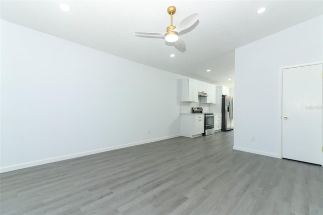 unfurnished living room featuring a ceiling fan, recessed lighting, baseboards, and light wood finished floors