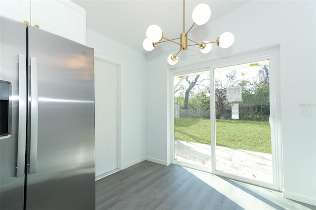 doorway to outside featuring baseboards, a chandelier, and dark wood-style flooring