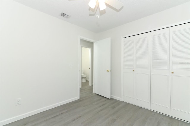 unfurnished bedroom with a closet, visible vents, ceiling fan, light wood-type flooring, and baseboards