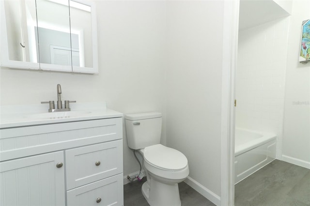 full bathroom with vanity, wood finished floors, toilet, and baseboards