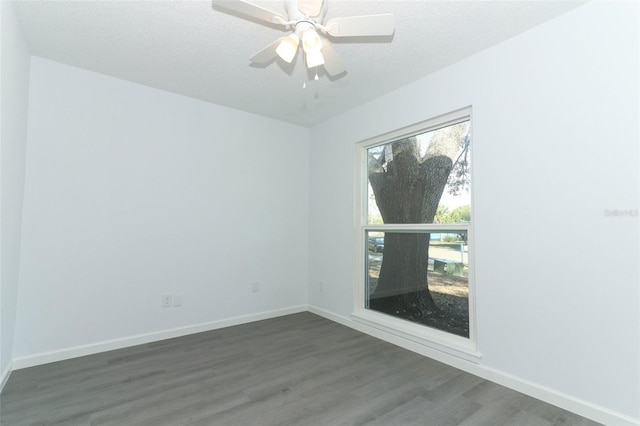 unfurnished room with a ceiling fan, a textured ceiling, baseboards, and wood finished floors