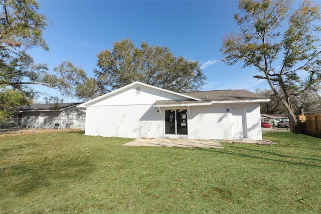 rear view of house featuring a yard, a patio area, and fence