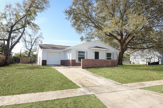 view of front of property with concrete driveway, an attached garage, fence, a front lawn, and brick siding