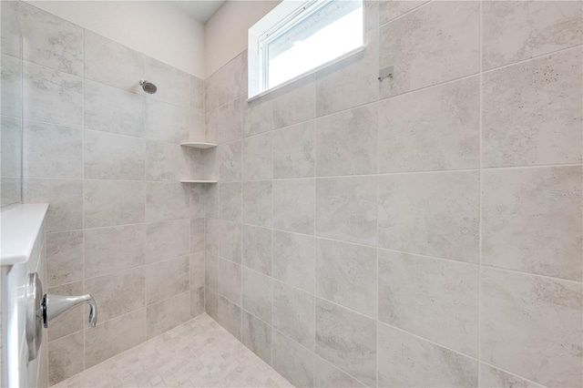 full bathroom with tiled shower