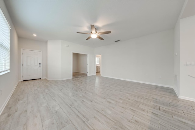 spare room featuring light wood finished floors, recessed lighting, visible vents, a ceiling fan, and baseboards