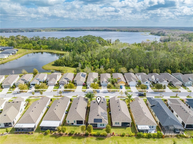 birds eye view of property with a water view and a residential view