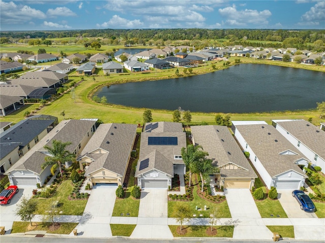 drone / aerial view with a water view and a residential view