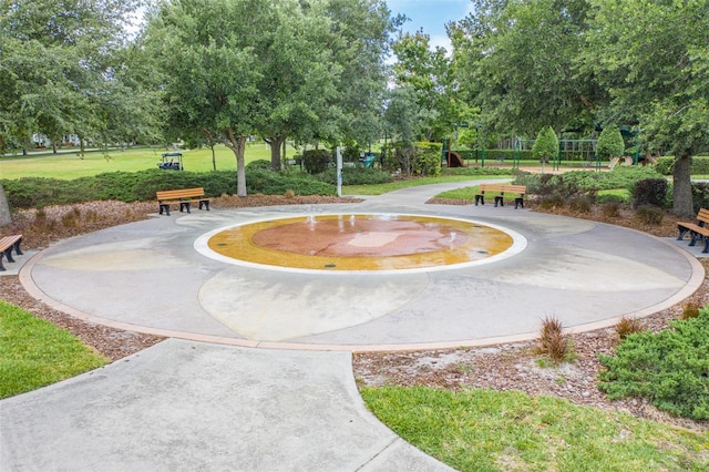 view of community with playground community and a lawn