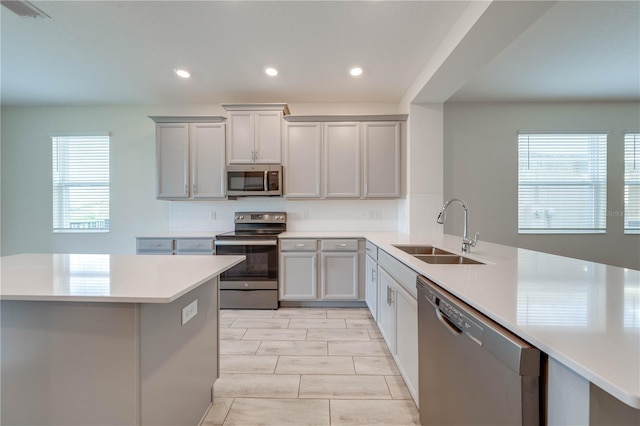 3415 Sagebrush St, Harmony, FL 34773 - kitchen with appliances with stainless steel finishes, light countertops, gray cabinetry, recessed lighting, and a peninsula