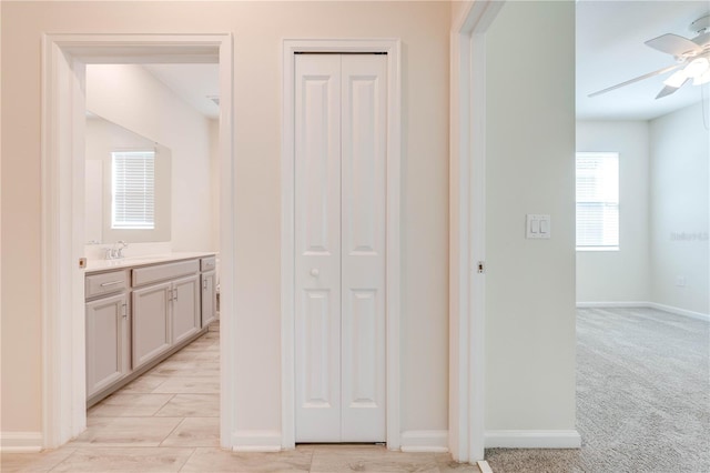 3415 Sagebrush St, Harmony, FL 34773 - corridor featuring baseboards and a sink