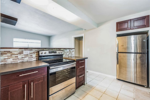 kitchen with decorative backsplash, dark countertops, baseboards, and appliances with stainless steel finishes