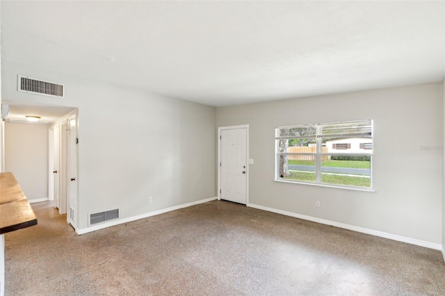 empty room with visible vents and baseboards