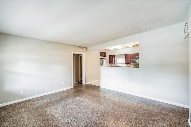 unfurnished room featuring baseboards