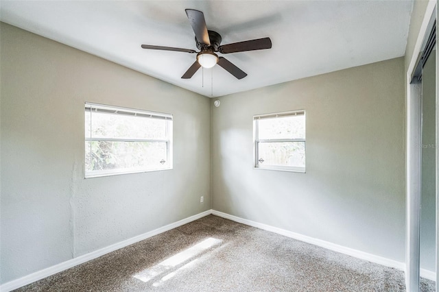 unfurnished room with ceiling fan, baseboards, and carpet floors