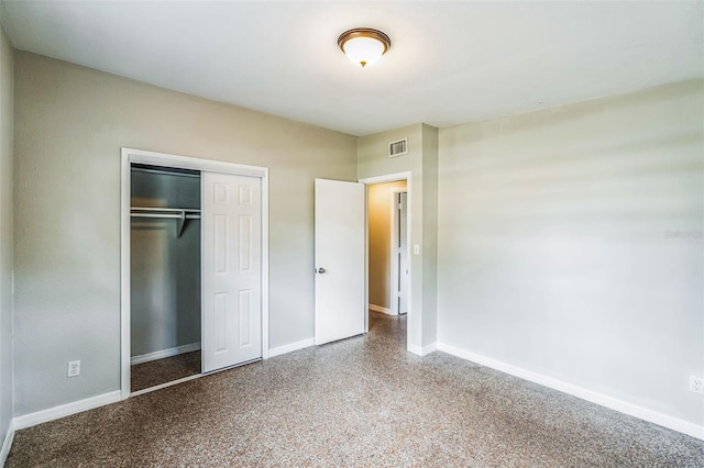 unfurnished bedroom featuring baseboards, visible vents, and a closet