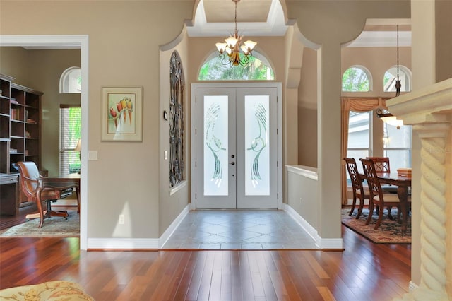 foyer entrance featuring a chandelier, french doors, and hardwood / wood-style flooring