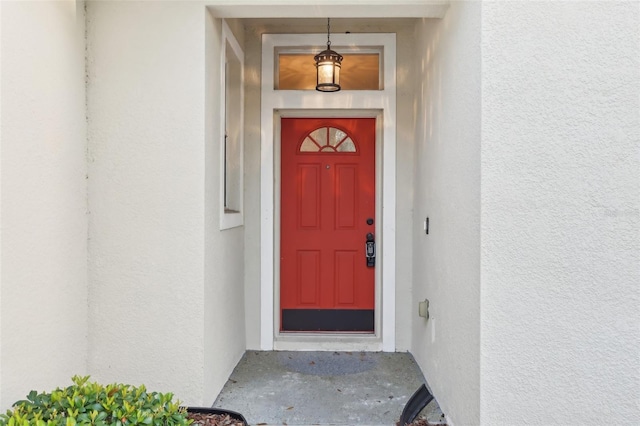 view of exterior entry featuring stucco siding