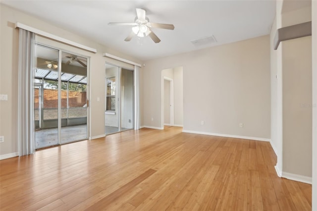 empty room with light wood finished floors, visible vents, baseboards, and ceiling fan