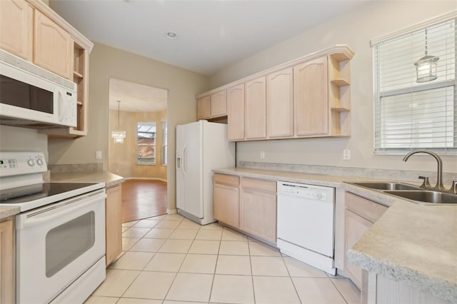 kitchen with a sink, white appliances, open shelves, and light brown cabinetry