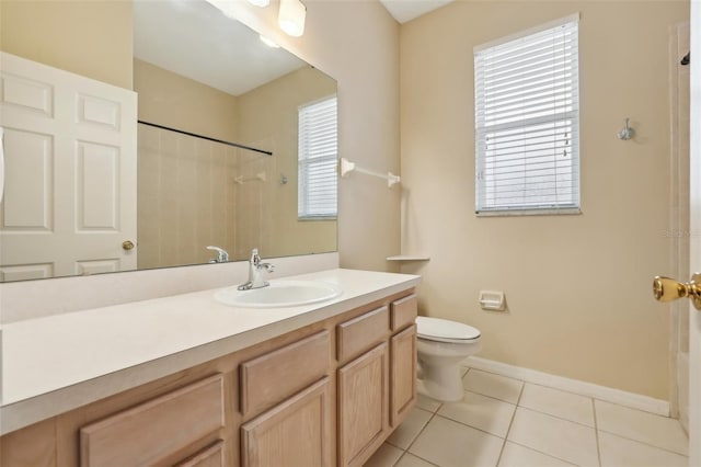 bathroom featuring tile patterned floors, baseboards, toilet, and vanity