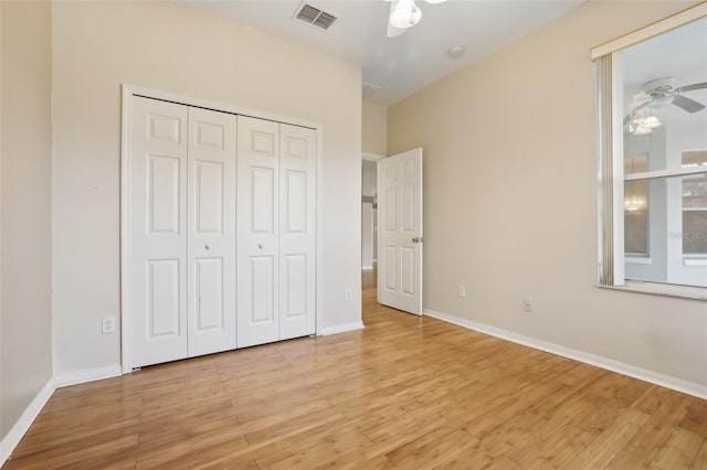 unfurnished bedroom featuring visible vents, baseboards, a closet, and light wood finished floors