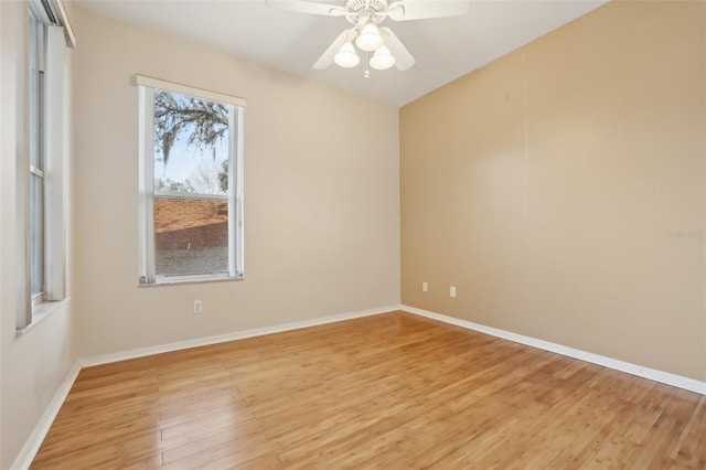 empty room with baseboards, light wood-style floors, and ceiling fan