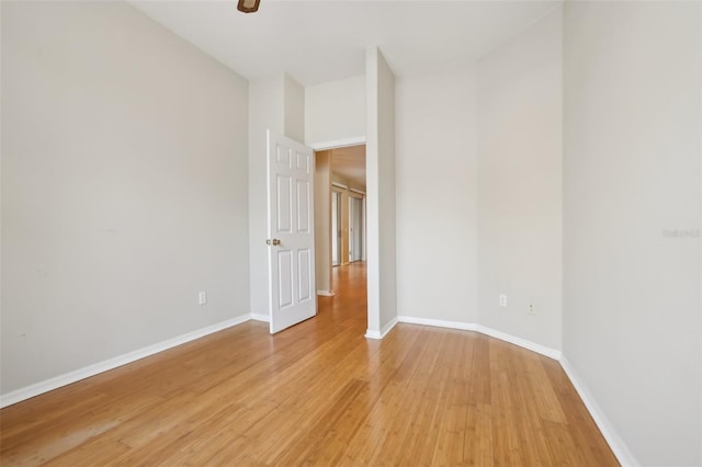 unfurnished room featuring baseboards and light wood finished floors