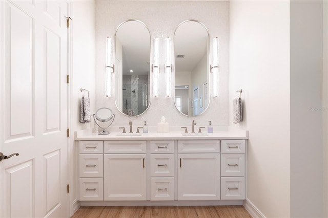 2161 Snow Rd, Orlando, FL 32814 - full bathroom featuring double vanity, wood finished floors, and a sink