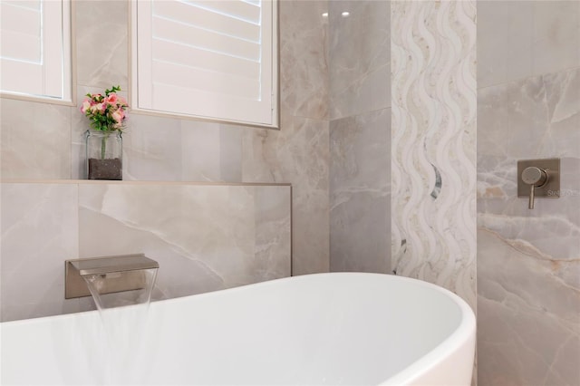 2161 Snow Rd, Orlando, FL 32814 - bathroom featuring a freestanding bath and tile walls