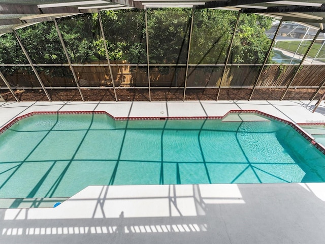 view of swimming pool featuring a patio area, a lanai, and a fenced in pool