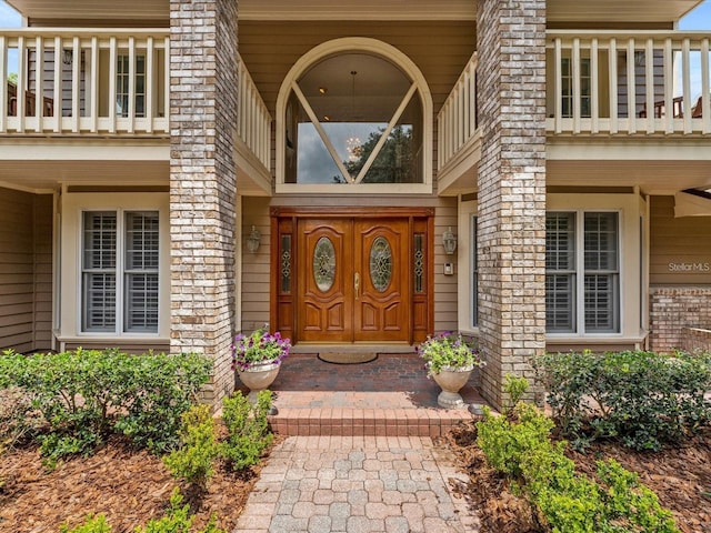 view of exterior entry with brick siding