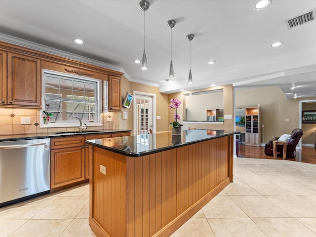 kitchen featuring light tile patterned floors, visible vents, brown cabinetry, stainless steel dishwasher, and a sink