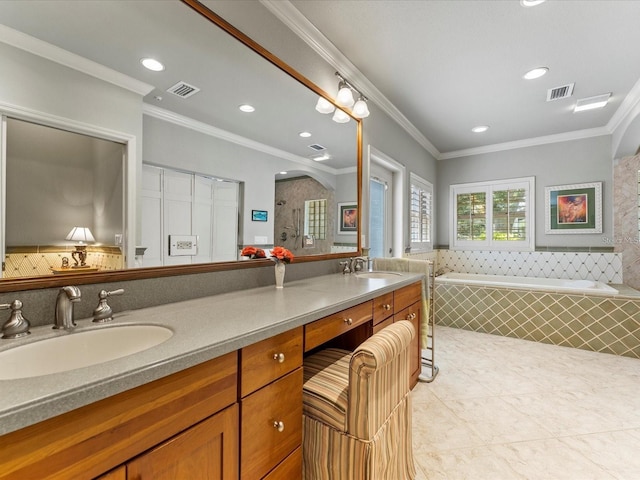 bathroom featuring a garden tub, double vanity, visible vents, ornamental molding, and a sink