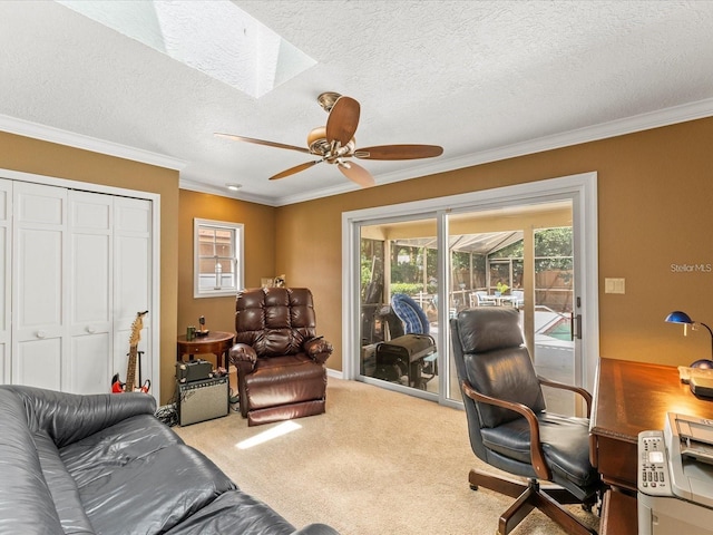 carpeted office space with ornamental molding, a sunroom, a textured ceiling, and a ceiling fan