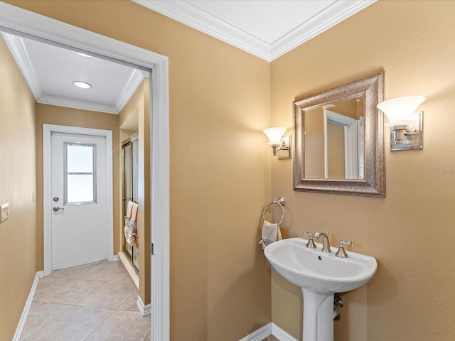 full bathroom with a shower stall, ornamental molding, baseboards, and tile patterned floors