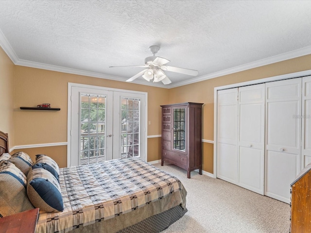 bedroom with french doors, a closet, light carpet, a textured ceiling, and access to outside