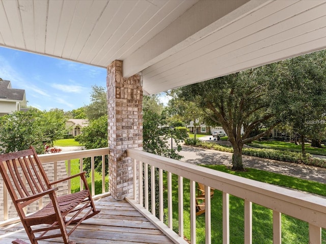 wooden terrace featuring a residential view and covered porch