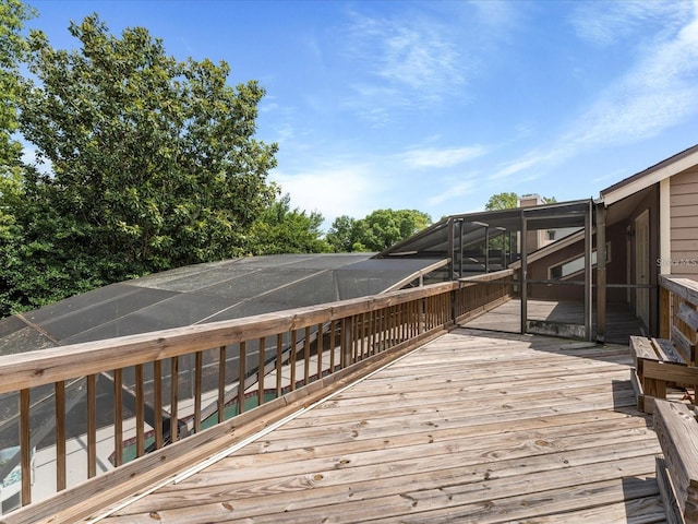 wooden deck featuring glass enclosure