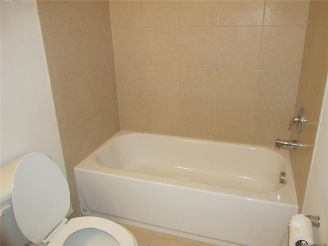 bathroom with a bathtub, a shower, toilet, and tile patterned floors