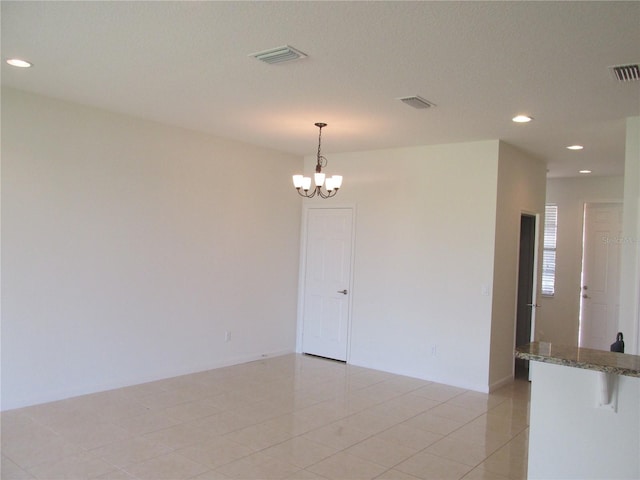 unfurnished room with visible vents, a notable chandelier, and recessed lighting