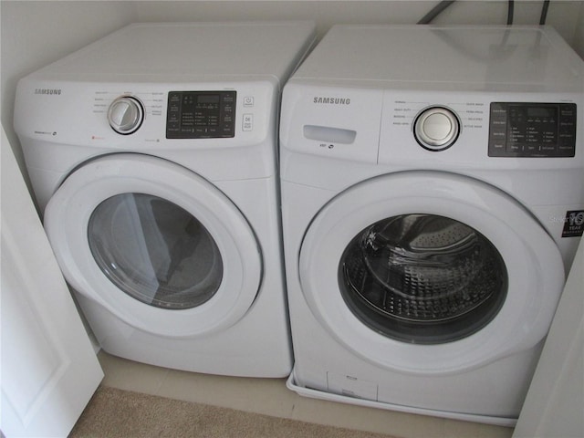 clothes washing area featuring washer and dryer and laundry area