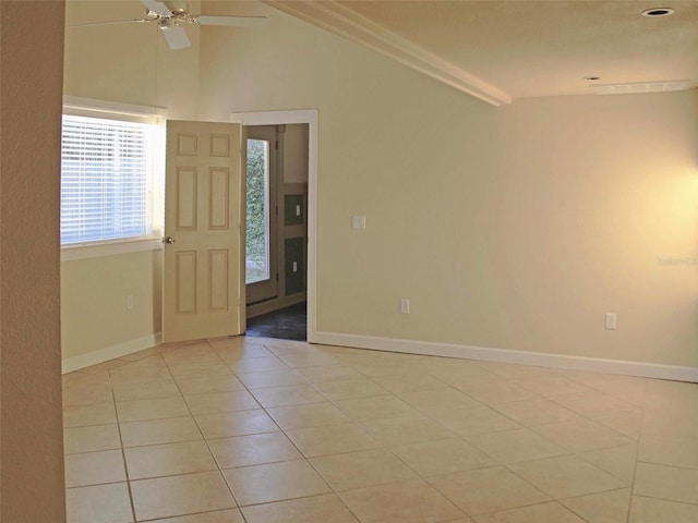 foyer featuring lofted ceiling, light tile patterned flooring, ceiling fan, and baseboards