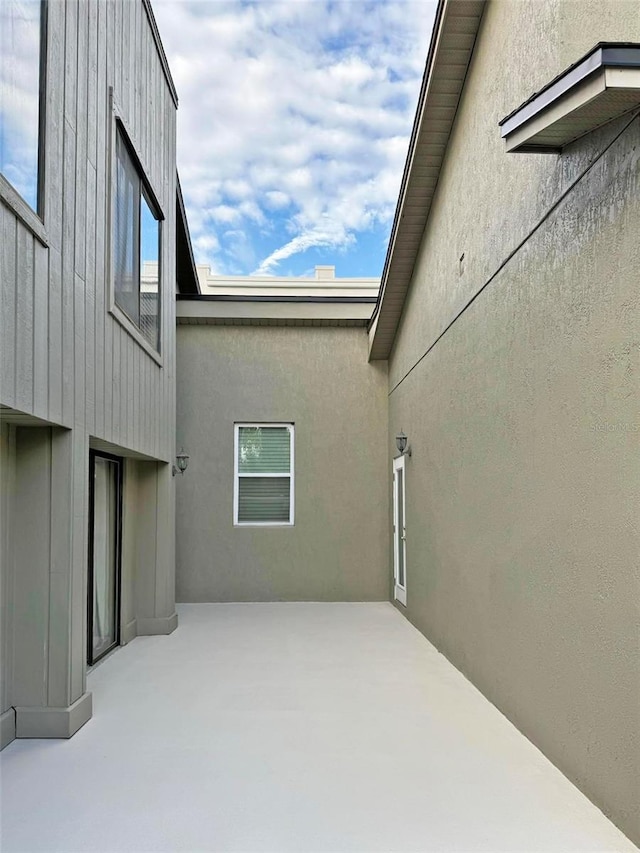 exterior space with a patio area and stucco siding