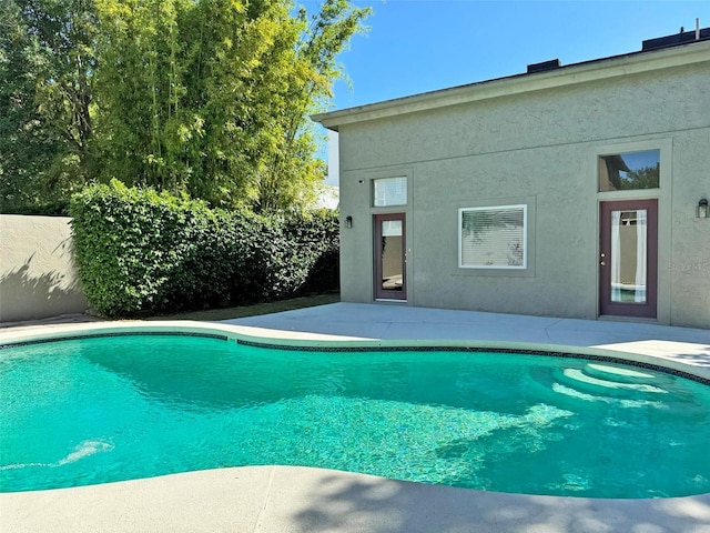 view of swimming pool with a fenced in pool and a patio