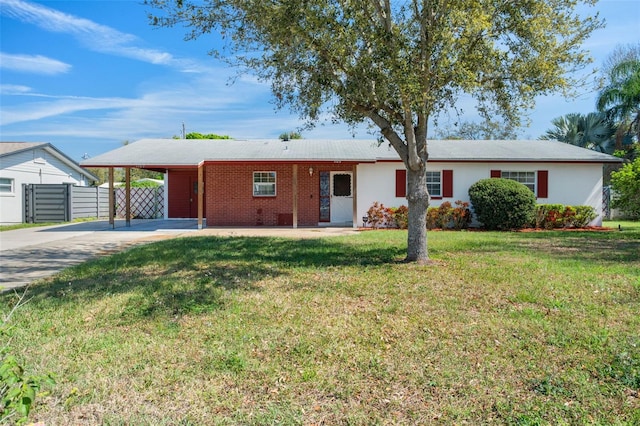 ranch-style house with driveway, fence, a front yard, a carport, and brick siding