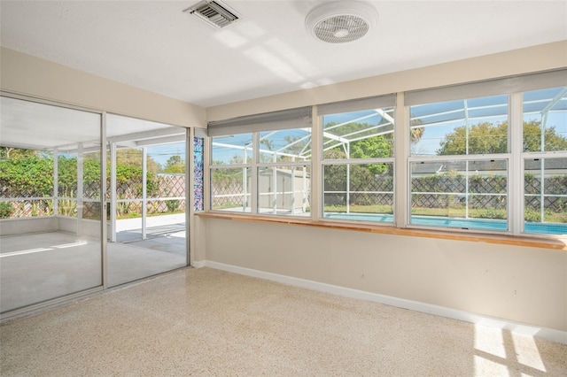 unfurnished sunroom featuring visible vents